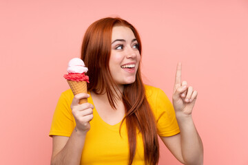 Young girl with a cornet ice cream over isolated background intending to realizes the solution while lifting a finger up