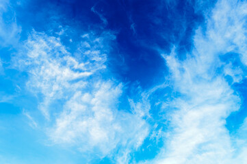 Blue sky background. Cloudy blue sky. Blue sky Abstract background with Dramatic tiny clouds floating. Fluffy Cloud Texture From A Perfect Cloudy spring time of day.
