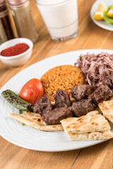 Traditional lamb skewers kebab with bulgur pilaf.