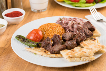 Traditional lamb skewers kebab with bulgur pilaf.