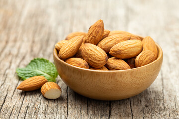 Almonds in Wooden bowl on old wooden table