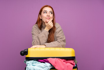 Traveler teenager girl with a suitcase full of clothes thinking an idea