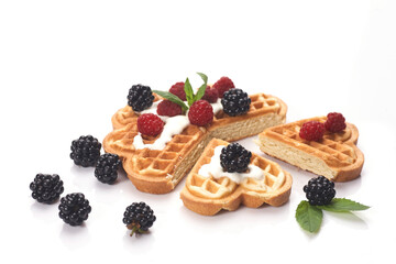 Belgium waffles with fresh berries isolated on white background