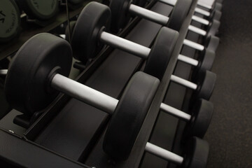 Naklejka premium Background of dumbbells on rack in fitness and workout room.Selective focus
