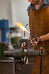 A blacksmith work on metal