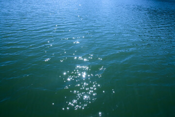 The water surface of the lake shining from the sun