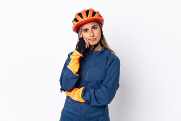 Young hispanic cyclist woman isolated on white background thinking an idea
