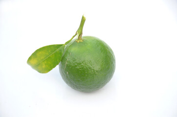 the ripe green orange fruit with leaves isolated on white background.