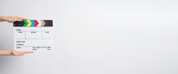 Two Hand is holding clapperboard or movie slate.It 's used in video production and film industry on white background.