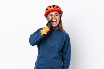 Young hispanic cyclist woman isolated on white background shouting with mouth wide open