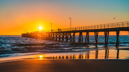 People walking on Port Noarlunga jetty at sunset, South Australia