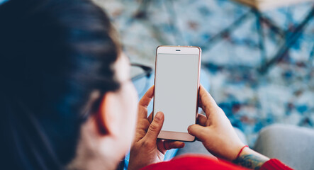 Woman using smartphone in living room at home