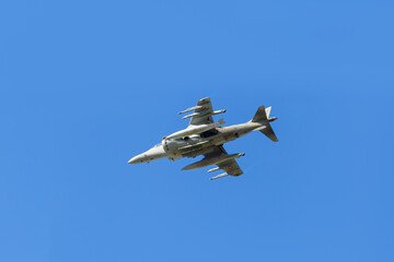 Modern armed military fighter jet flys in formation through the sky.