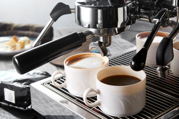 Two cups of coffee on the coffee machine,closeup