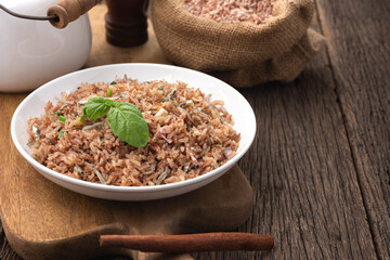 brown rice fire with small fish on wood