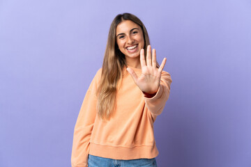 Young hispanic woman over isolated purple background counting five with fingers
