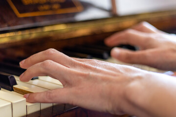 A female musician performing classical music on an antique piano