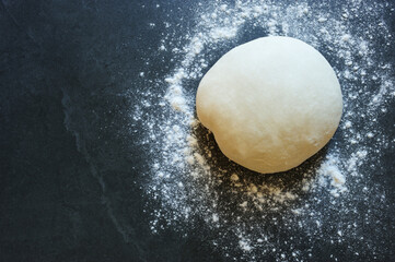 Dough with floor on the gray stone board.