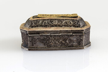 Ancient decorative box made of gold and silver isolated on white. Antiques in the collection of the Pedir Museum, Aceh, Indonesia.