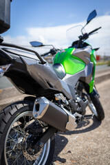Rear profile view of a green Kawasaki Versys X 300  adventure-style motorcycle