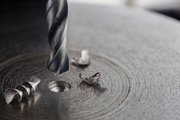 metal drill bit make holes in steel billet on industrial drilling machine. Metal work industry....
