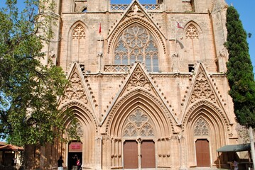 Obraz premium Tourists visit Lala Mustafa Pasha Mosque or Saint Nicholas Cathedral church dated back 13th century in Rayonnant Gothic style. Famagusta Northern Cyprus