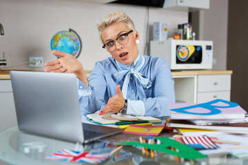 schocked indignant teacher is dissatisfied with pupils while having online lesson, online class via video chat on laptop pc