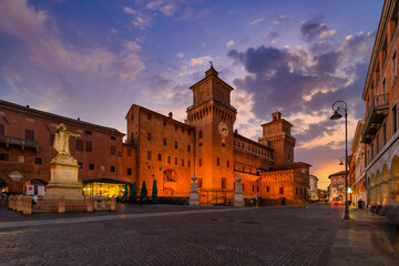 Fototapeta na wymiar Castle Estense (Castello Estense) and piazza Savonarola and monumet to Savonarola in Ferrara, Emilia-Romagna, Italy. Ferrara is capital of the Province of Ferrara