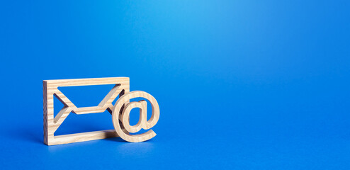 Email figure on blue background. Envelope and AT commercial sign symbol. Concept of email address....