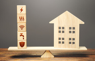 House and blocks with utilities public service symbols on scales. Availability of bill payment....