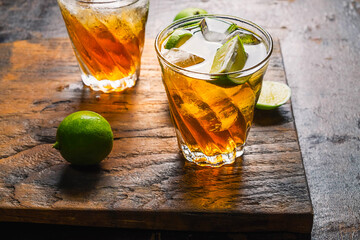 Iced lemon tea and lemon on a wooden table