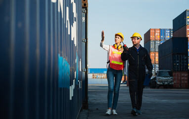 Two foreman man & woman worker working checking at Container cargo harbor to loading containers....
