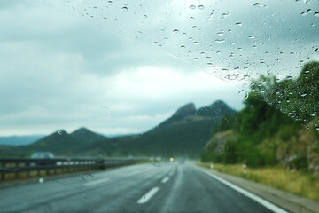 The raindrops on the blurred windscreen of the auto driving the roads of Croatia during the rain