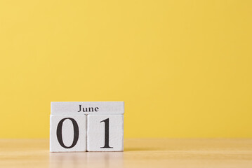 Wooden block calendar with date May 1 on the yellow background. Labor Day concept