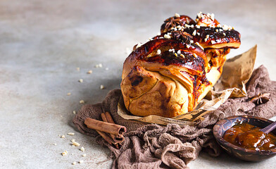 Swirl brioche with apricot jam, nuts, cinnamon and anise star. Braided or roll bread, Babka. Copy space.