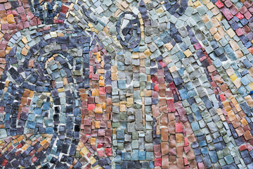Detail of a beautiful old crumbling abstract ceramic mosaic decoration. mosaic as a decorative background.