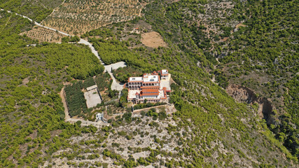 Fototapeta na wymiar Aerial drone photo of iconic monastery Prophet Elias or Profitis Ilias built on top of a cliff overlooking Loutraki town, Corinthian bay, Greece