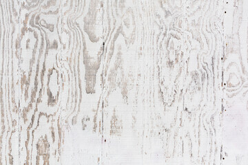 Close view of faded white painted plywood
