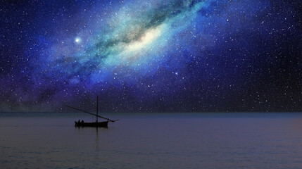 fishing boat sails under the milky way