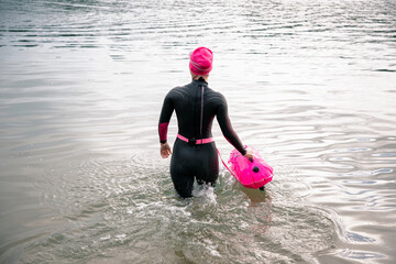 The athlete swimmer enters the water. Sports swimming, triathlon