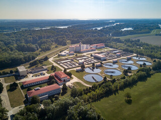 Wastewater treatment plant with river and forrest in background aerial drone shoot