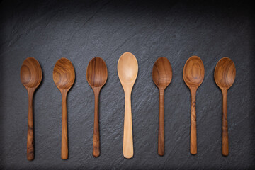 Empty many wooden spoons on the table black stone
