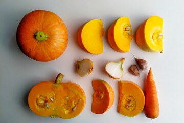 ingredients for making pumpkin cream soup on white background. Knoling. Raw food