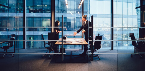 Serious colleagues discussing project in boardroom