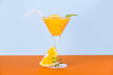 Fresh orange juice with mint leafs and a slice at the base