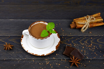 Hot chocolate with mint on a dark wooden background