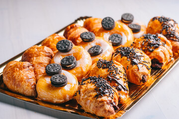 Croissants and chocolate donuts for breakfast sweet snacks on the table
