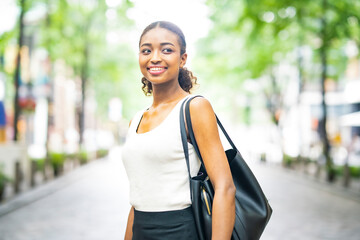 Young business woman in a green city