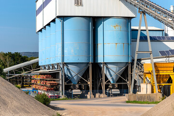 Big blue metallic Industrial silos for the production of cement at an industrial cement plant on...