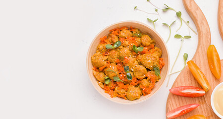 Dish of vegetarian soy meat with micro greens on a white plate. Copy space, banner